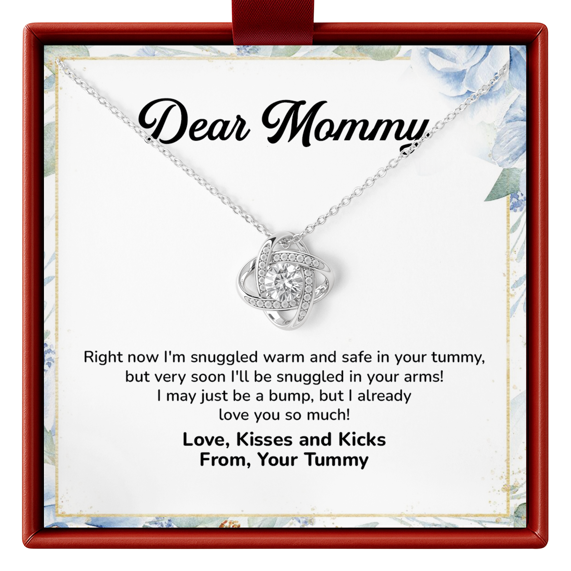 A silver necklace with a heart-shaped pendant set with small clear stones, presented on a white card inside a red gift box. The card is addressed 'Dear Mommy' and features a humorous baby quote.