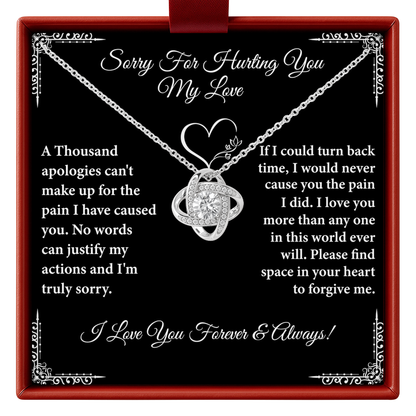 Necklace with heart design on a black background with apology message