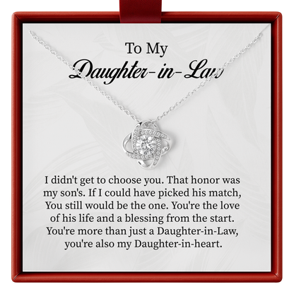 Silver necklace with a heart-shaped pendant on a card for daughter-in-law, placed in a red box.