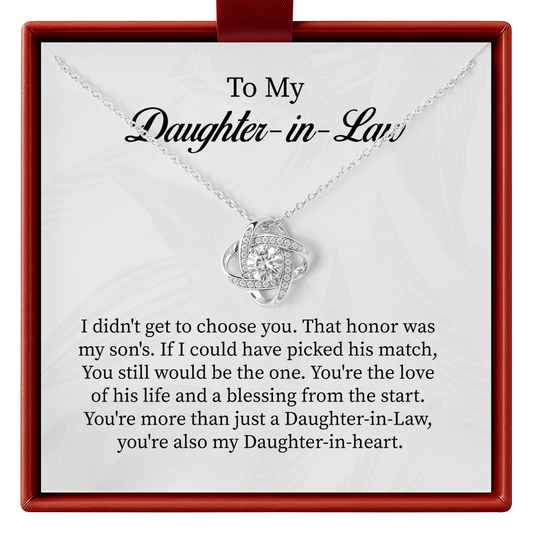 Silver necklace with a heart-shaped pendant on a card for daughter-in-law, placed in a red box.