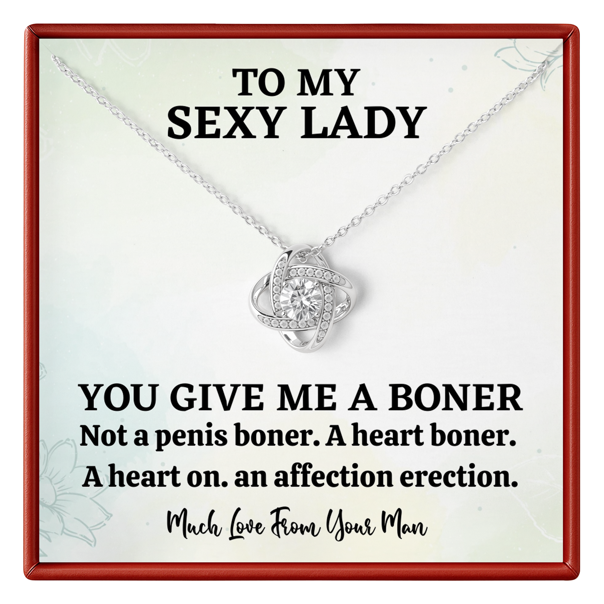 Necklace with heart pendant on a card with humorous text, displayed in a red border.