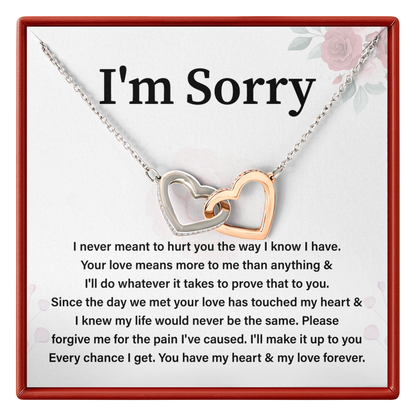 Necklace with interlocking hearts on a card with 'I'm Sorry' message
