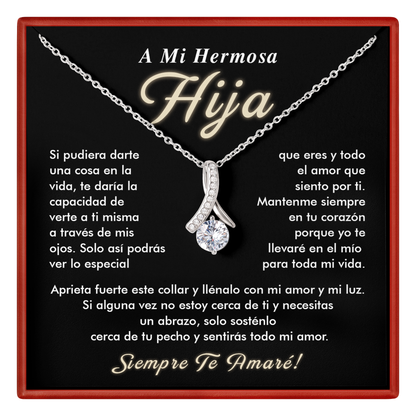 Necklace with a diamond pendant on a black card with Spanish text, framed by a red border.