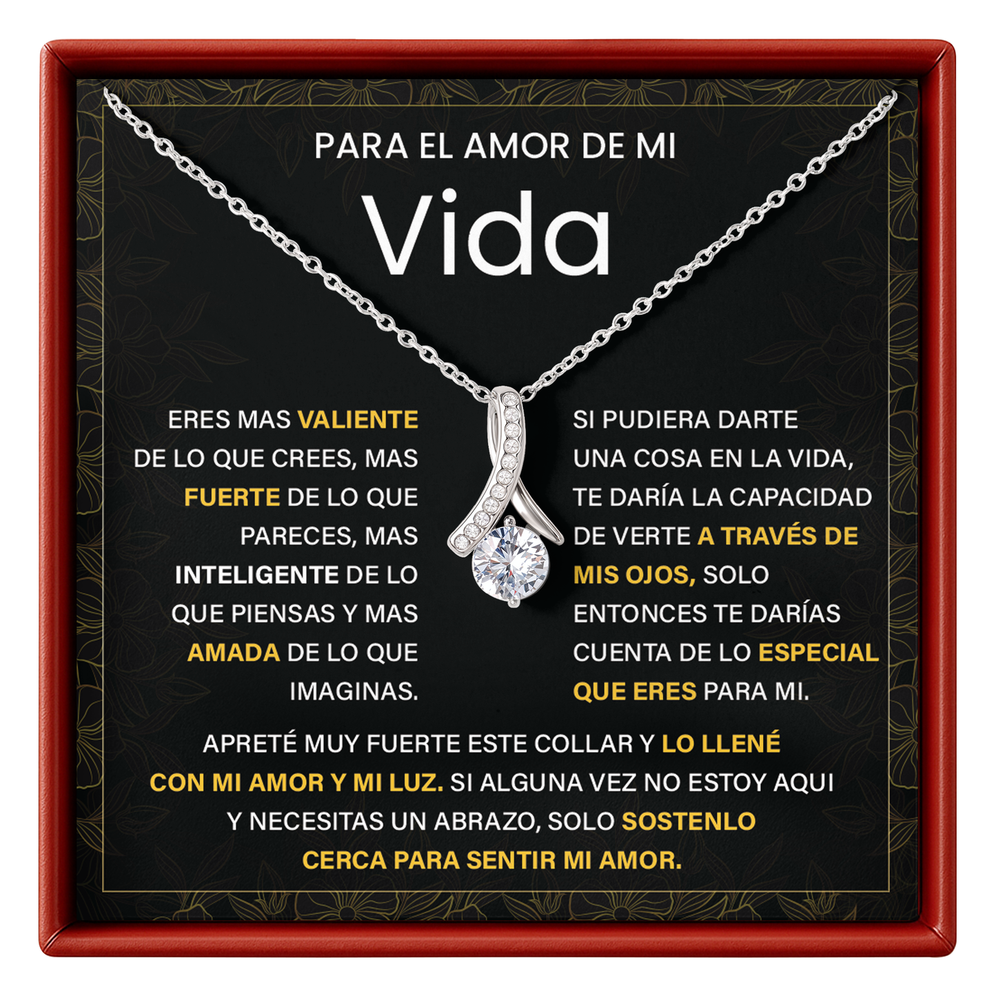 Silver necklace with a diamond pendant on a black card with text, framed by a red border.