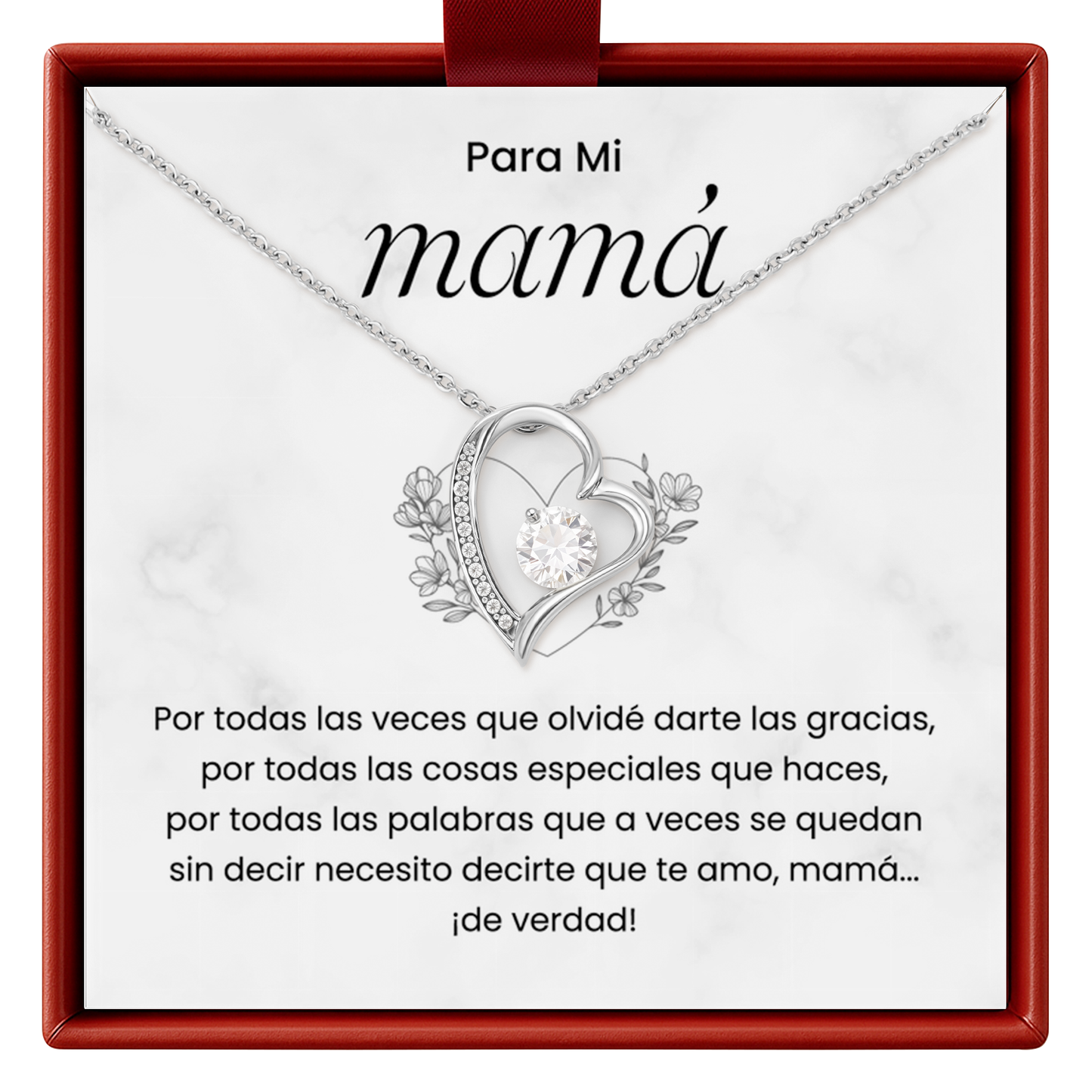Heart-shaped necklace with floral details on a white card with red border, featuring Spanish text.