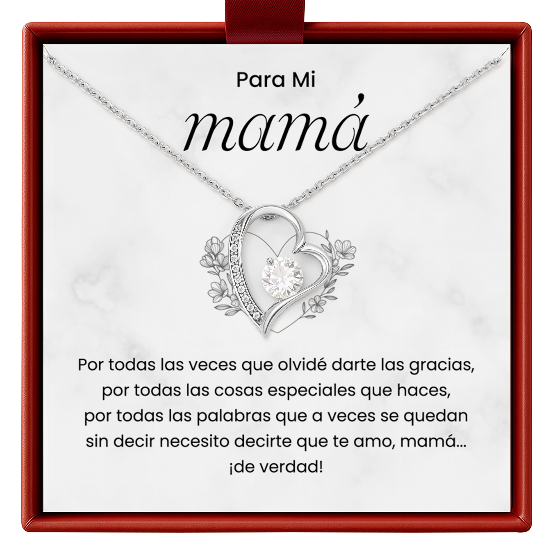 Heart-shaped necklace with floral details on a white card with red border, featuring Spanish text.