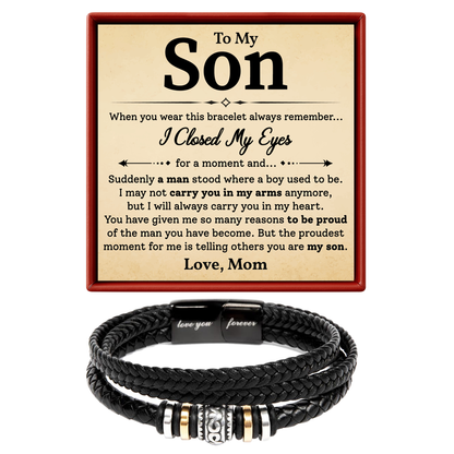 Black braided bracelet with engraved message on a card, displayed against a white background.