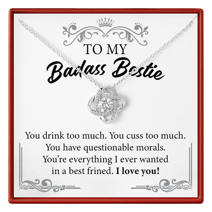 Necklace with heart-shaped pendant on a card that reads 'To my Badass Bestie' with humorous text.