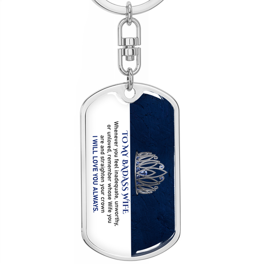 Dog tag keychain with engraved text and crown design on a white background